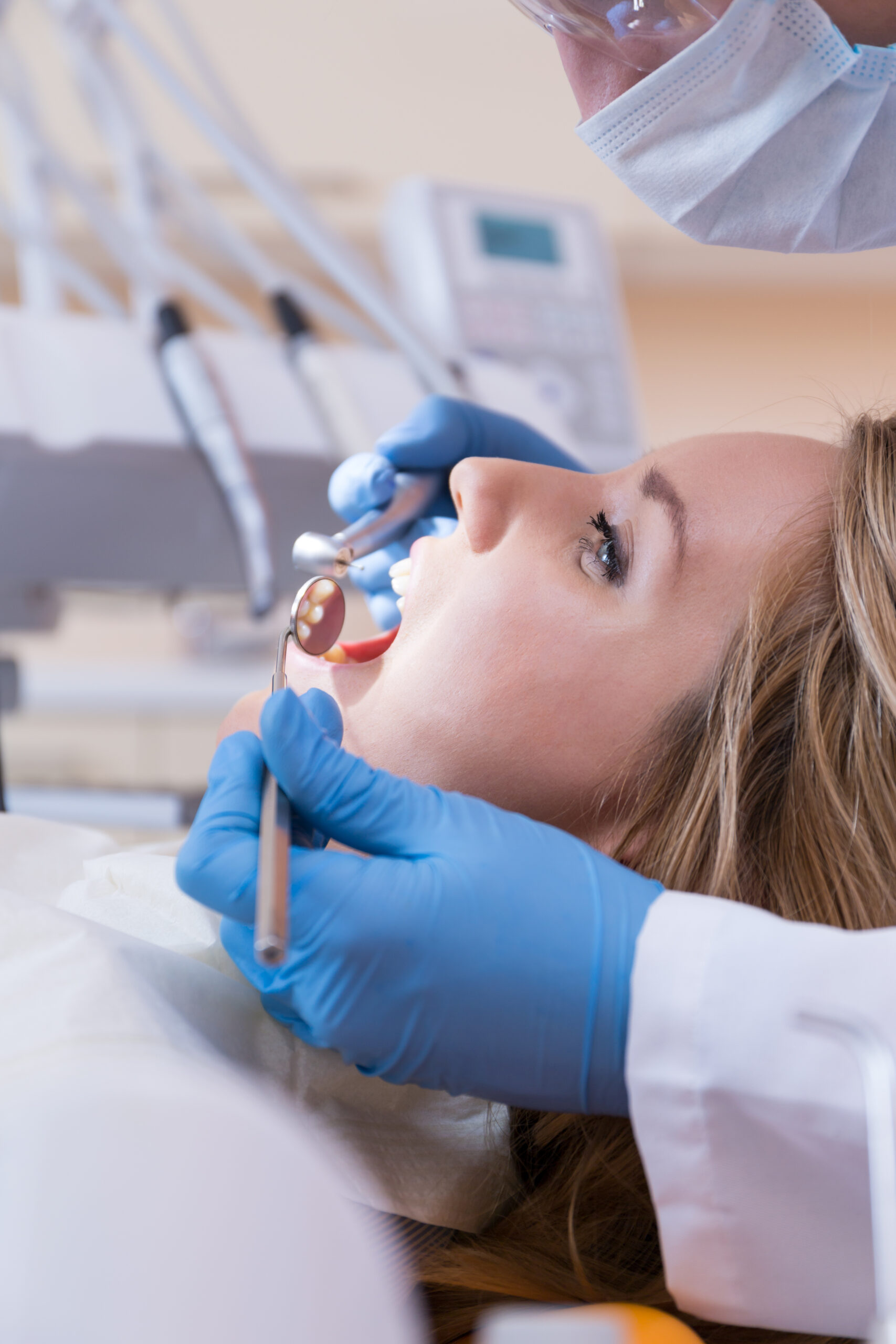 Using dental drill and mouth mirror